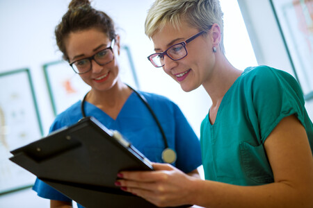 Per diem nurses reviewing a patient's records Per diem nurses reviewing a patient's records